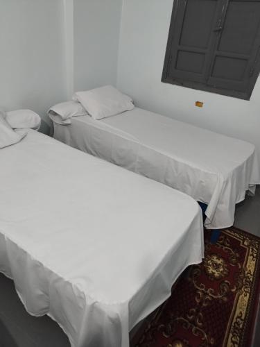 two beds sitting next to each other in a room at Grand Square Hostel Luxor in Luxor