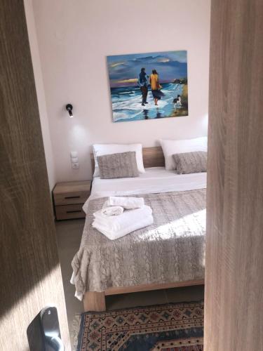 a bedroom with two beds and a painting on the wall at The sunny apartment Αριδαια-Λουτρά Ποζαρ in Aridaia