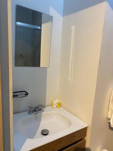 a white bathroom with a sink and a mirror at Premier Monterrey Retreat 5 in Monterrey