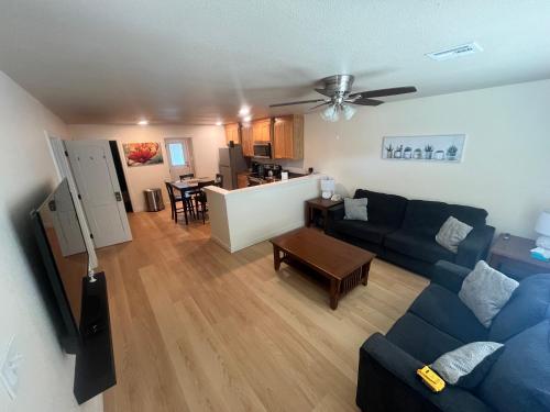 a living room with a blue couch and a kitchen at Prime Location to Casino Excitement 2 mi w King Beds in Thackerville