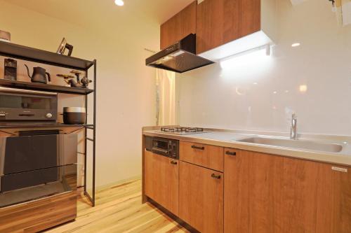a kitchen with a sink and a stove at V.Close to Shinjuku Kabukicho/Korean Town/FrWIFI D in Tokyo