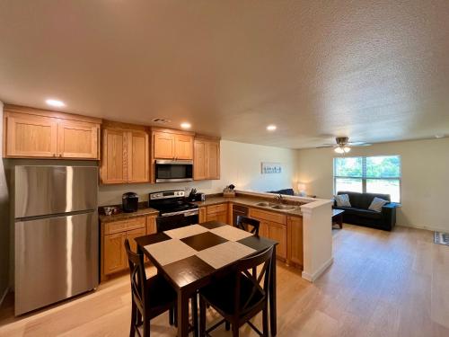 a kitchen with wooden cabinets and a table with a dining room at Prime Location to Casino Excitement 2 mi w King Beds in Thackerville