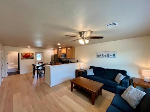 a living room with a blue couch and a kitchen at Prime Location to Casino Excitement 2 mi w King Beds in Thackerville