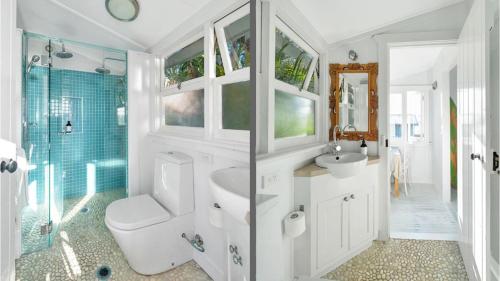 a bathroom with a toilet and a sink and a shower at Aurora quintessential beachfront couples getaway in Currarong