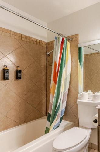 a bathroom with a shower curtain and a toilet at Oasis in the desert with huge heated Pool and SPA in Las Vegas