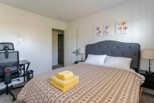 a bedroom with a bed with yellow towels on it at Oasis in the desert with huge heated Pool and SPA in Las Vegas