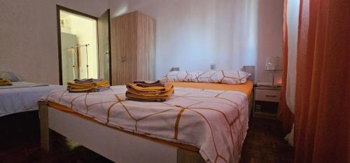 a bedroom with two beds with towels on them at Apartments by the sea Gornji Karin, Novigrad - 11806 in Gornji Karin