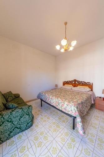 a bedroom with two beds and a chandelier at Appartamento - Ladispoli in Ladispoli