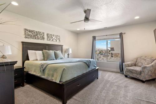 a bedroom with a bed and a chair and a window at Hot Tub King Beds Pool Fire Pit BBQ in Washington