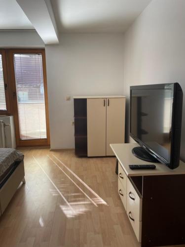 a room with a bed and a television on a desk at BT Lux apartment 2 in Skopje