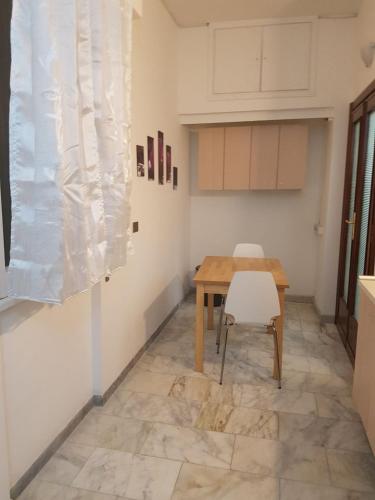 a kitchen with a wooden table and a chair at Residence Emporium in Rome