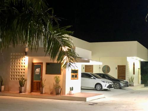 two cars parked outside of a building at night at บ้านศรีสุธรรม 2 Baansrisuthum 2 in Surat Thani