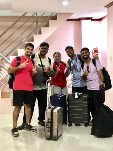 a group of men posing for a picture with luggage at Baansrisuthum in Don Sak