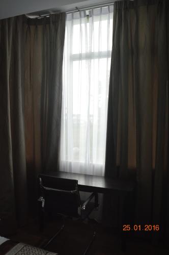 a window with curtains and a table in front of it at Qu Lin Resident in Sibu