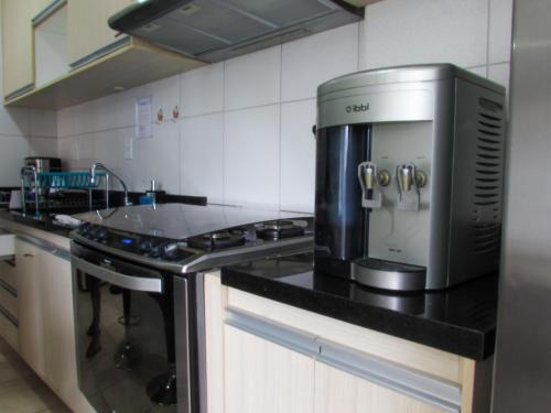 a kitchen with a coffee maker on a counter at APARTAMENTO TRiNDADE in Manaus