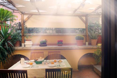 a table in a restaurant with plants on the wall at Palazzo Maggiore in Tivoli