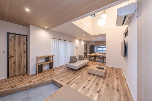 a living room with a couch and a table at Apartment Hotel 11 Villa Hanazonocho in Osaka