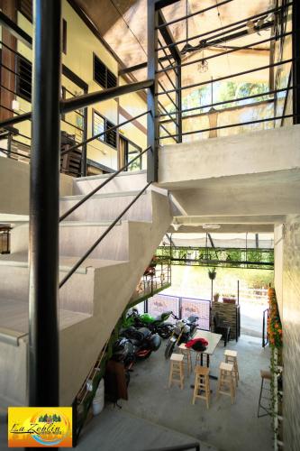 a staircase in a building with a table and chairs at La Zeblin Beach House in Zambales