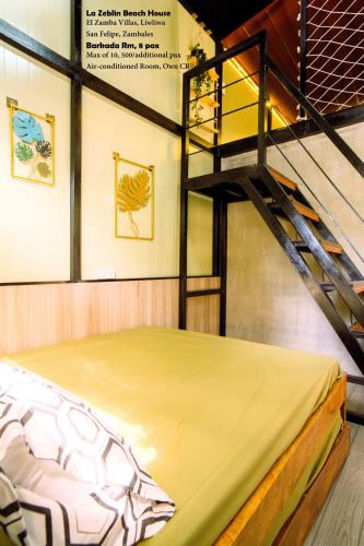 a bunk bed in a room with a staircase at La Zeblin Beach House in Zambales