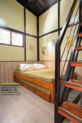 a bedroom with a bunk bed and a staircase at La Zeblin Beach House in Zambales