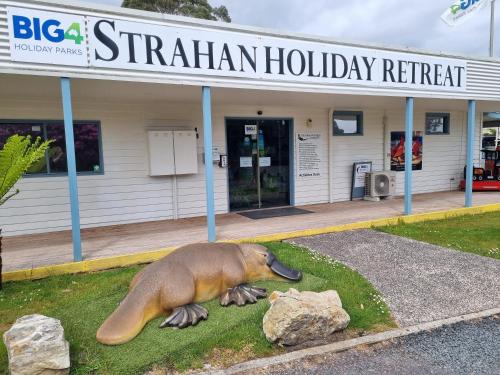 a platypus statue in front of a building at BIG4 Strahan Holiday Retreat in Strahan