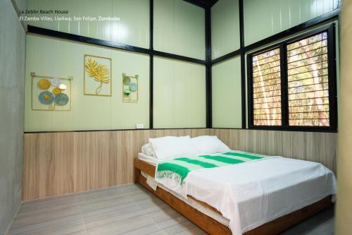 a bedroom with a bed in a room at La Zeblin Beach House in Zambales