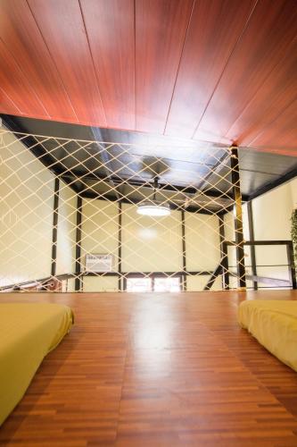 a room with two beds and a ceiling at La Zeblin Beach House in Zambales