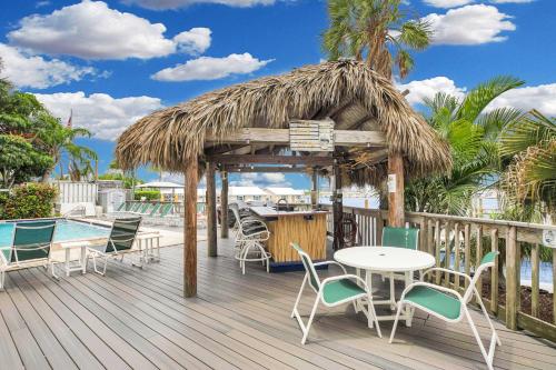 a deck with a table and chairs and a pool at St Thomas - Waterfront Penthouse sleeps 16 w Pool & Boat Dock in Key West
