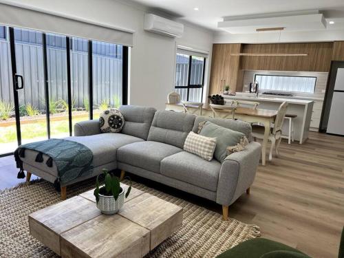 a living room with a couch and a table at The Cosy Cottage in Ararat