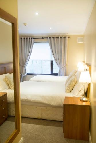 a bedroom with a large bed and a window at Hillview House in Lusk