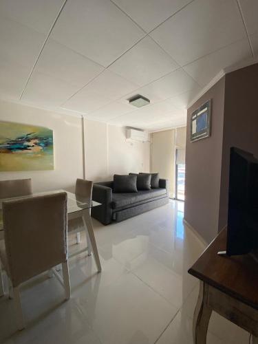 a living room with a couch and a table at Depto Centrico Exclusivo in Villa Carlos Paz