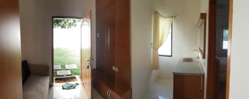 a bathroom with a sink and a mirror at Pool Villa Saung Suluh in Purwokerto