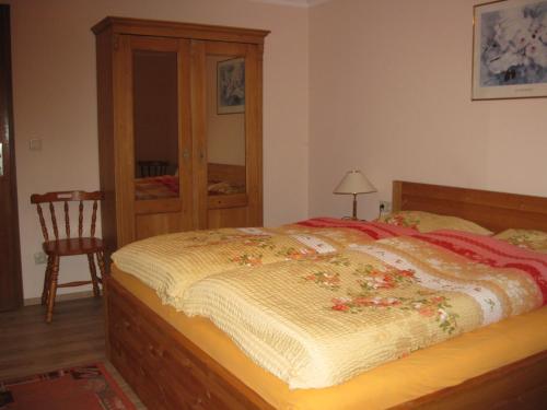 a bedroom with a bed and a chair in it at Ferienwohnung Kulla in Albstadt