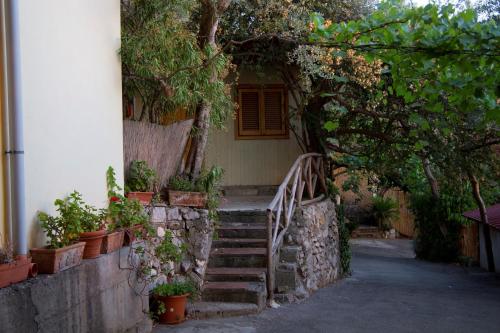 a stairway leading to a house with potted plants at Baia Serena in Vico Equense