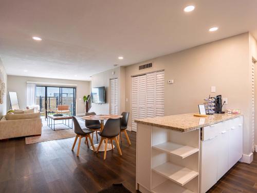 a kitchen and living room with a table and chairs at Boho Townhouse near USF in Tampa