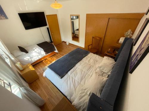 a bedroom with a bed and a television in it at Hostal Roma Condesa in Mexico City