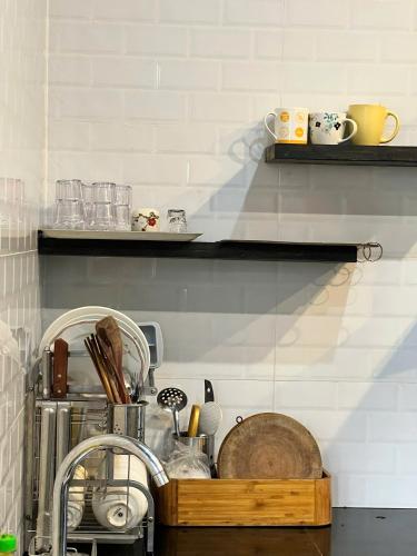 a kitchen with a sink and a counter with dishes at Kimi Uchi Home in Da Lat