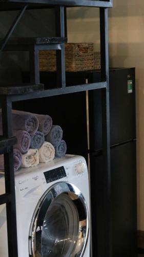 a washing machine sitting on top of a shelf at Kimi Uchi Home in Da Lat