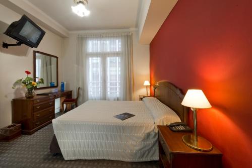 Una cama o camas en una habitación de Crisol Suites Catalinas