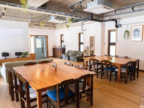 a large room with wooden tables and chairs at SOLAIZ Ishigaki Island in Kabira