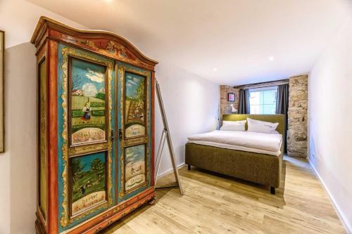 a bedroom with a china cabinet next to a bed at Hotel-Restaurant Kostbar in Engen