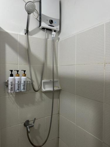 a shower in a bathroom with a shower head at Zoe Studio Mesavirre in Bacolod