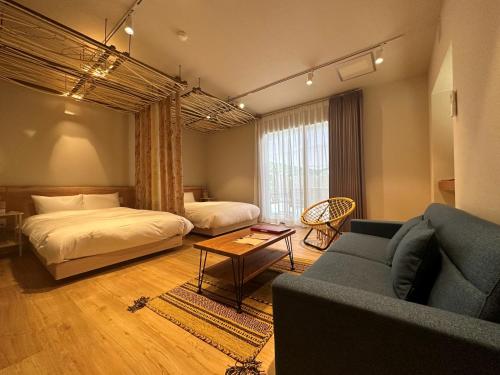 a living room with a bed and a couch and a living room at Mieux Forest in Uenohara
