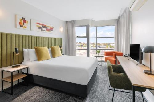 a hotel room with a bed and a desk at Quest Caroline Springs in Caroline Springs