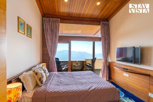 a bedroom with a bed and a large window at StayVista at Cheerio - Elysium Estate 2BR Cottage with Valley View in Shimla