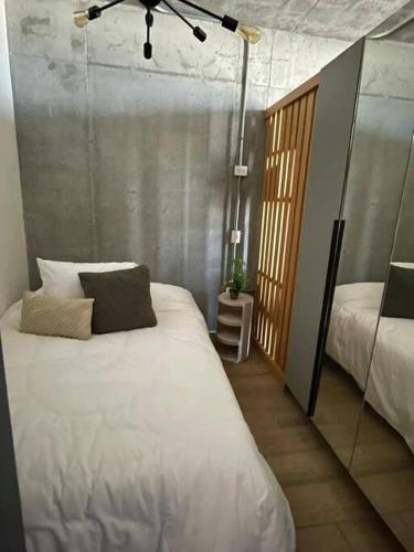 a bedroom with a large white bed with two pillows at Prime Monterrey Stay 7 in Monterrey