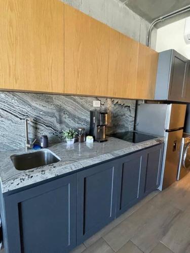 a kitchen with a sink and a counter top at Prime Monterrey Stay 7 in Monterrey