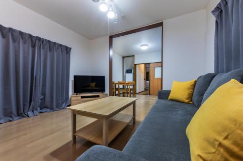 a living room with a couch and a table at Kaori 香 in Osaka
