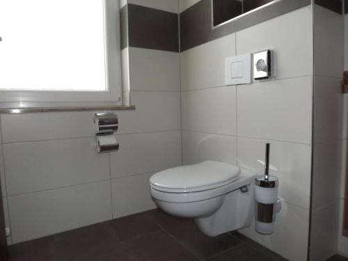 a bathroom with a white toilet and a window at Hotel zum Weissen Ochsen in Aalen