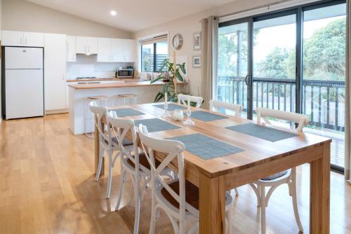 a kitchen and dining room with a wooden table and chairs at Kanangra Place, Yarra Valley in Woori Yallock